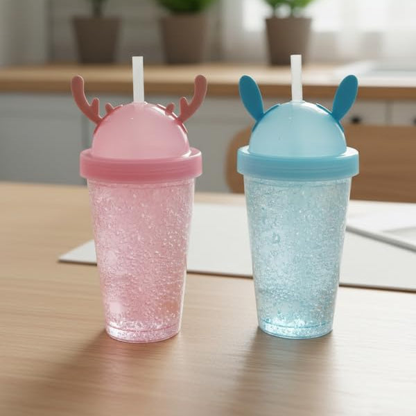 Two glittery tumbler cups with animal-themed lids on a wooden surface.